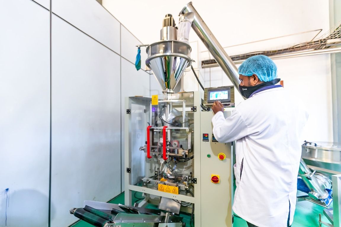 An operator at the powder packing machine
