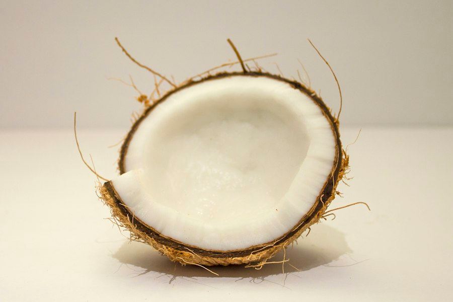 A halved coconut showing the white flesh